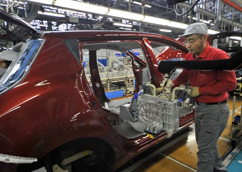 japan   january 24  japanese nissan factory in oppama, japan on january 24, 2011   a worker installs battery chargers in car bodies of nissann electric vehicle leaf on its assembly line at nissan oppama technical center in kanagawa pref  photo by kasahara katsumi gamma rapho via getty images