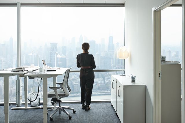 elegant businesswoman working alone in office building