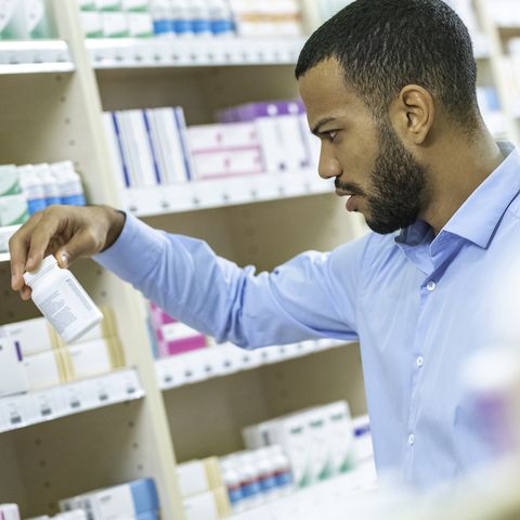 man reading label on medication