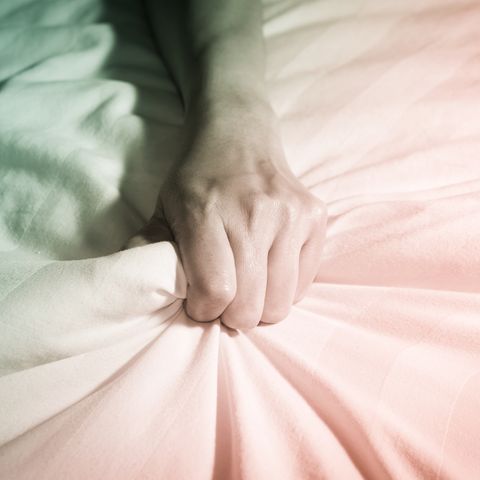 woman hand squeezing blanket on bed,multi color filtered