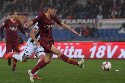 as roma bosnian forward edin dzeko shoots to open the scoring during the italian serie a football match as roma vs udinese on april 13, 2019 at the olympic stadium in rome photo by tiziana fabi  afp        photo credit should read tiziana fabiafp via getty images