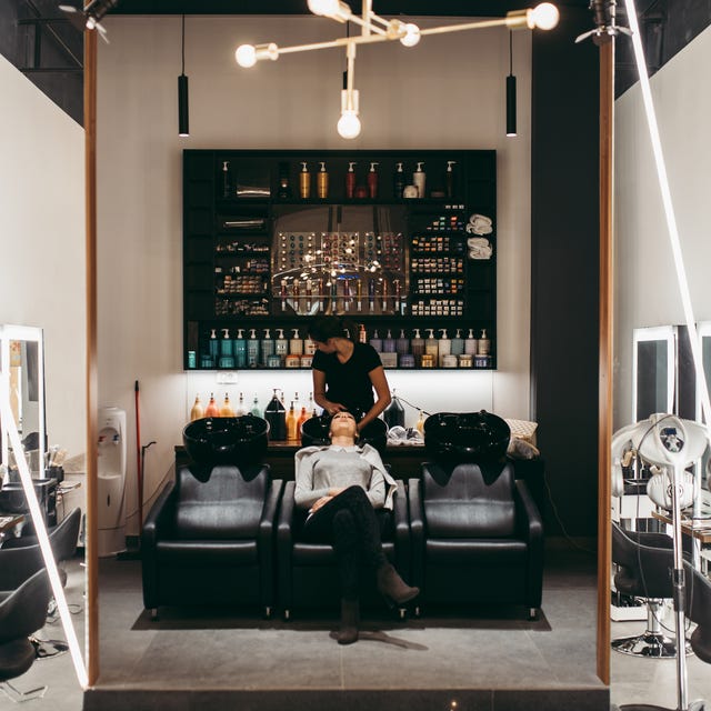 beautiful young woman getting a hair wash hair salon styling concept