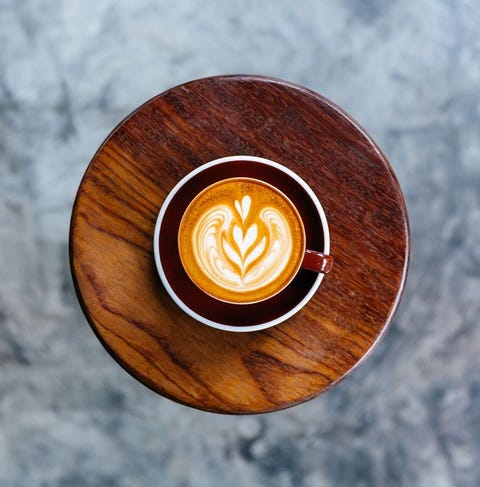 Cup of coffee standing on a round coffee table