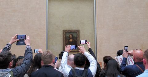 12 april 2019, france france, paris visitors stand with their mobile phones and smartphones in front of leonardo da vincis mona lisa in the louvre day in, day out, theres this spectacle at the louvre in paris   in front of the mona lisa the world famous painting created by leonardo da vinci more than 500 years ago attracts millions of visitors every year it is one of the most visited works of art in the world   and yet it is hardly considered to dpa korr a selfie with the mona lisa from 22042019 photo sabine glaubitzdpa photo by sabine glaubitzpicture alliance via getty images