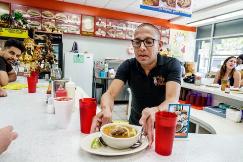 Miami, Little Havana, El Rey de las Fritas, server with Ajiaco Soup miami, little havana, el rey de las fritas, server with ajiaco soup photo by jeffrey greenberguniversal images group via getty images