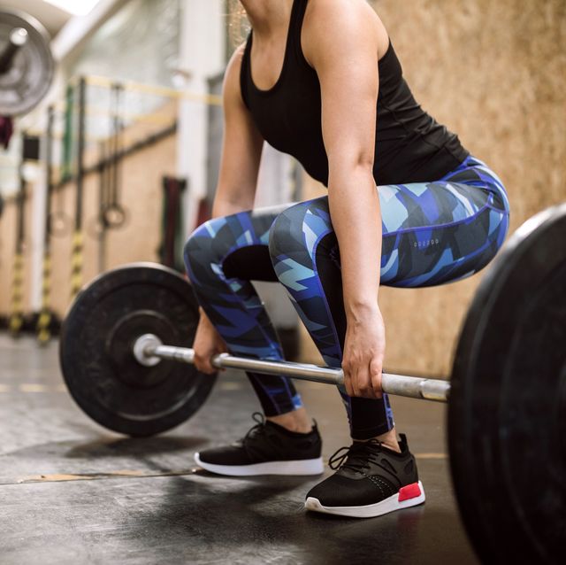 woman athlete weightlifting warm up exercises on cross training