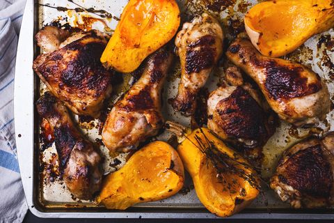 Baked chicken legs, butternut squash and thyme herb background
