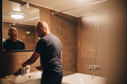 guy brushing his teeth men's health