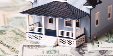 house on different dollar bills real estate concept