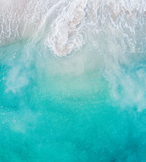 Abstract wave patterns washing ashore seen from above, Barbados