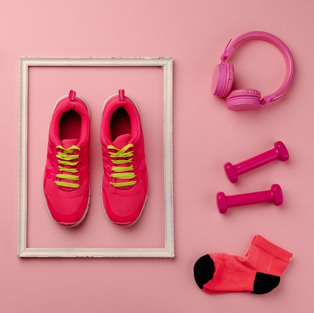 A Studio Shot Of Running Shoes And Other Sport Equipment On Color Background