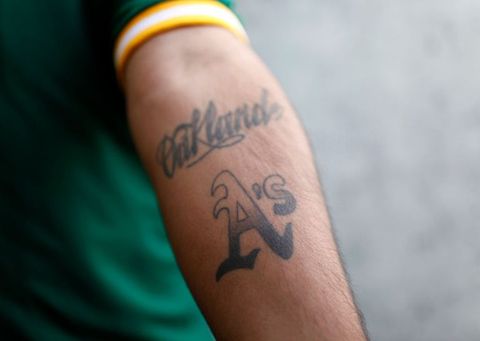 oakland athletics fan jorge leon shows off his only oakland as tattoo on this left forearm in the right field bleacher seats before their game against the boston red sox at the oakland coliseum in oakland, calif on monday, july 19, 2010  nhat v meyermercury news photo by medianews groupbay area news via getty images