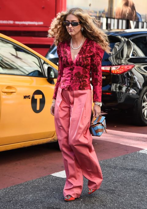 new york, new york   september 07 a guest is seen wearing a red floral top and pink pants outside the self portrait show during new york fashion week ss20 on september 07, 2019 in new york city photo by daniel zuchnikgetty images