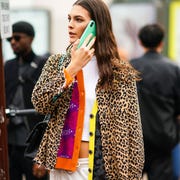 a model wears a white crop top, a purple orange and yellow grey jacket, a leopard print ripped hem jacket, adidas creamcolor sport pants, outside paco rabanne, during paris fashion week womenswear spring summer 2020