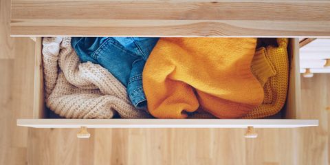 open drawer with jeans and sweaters