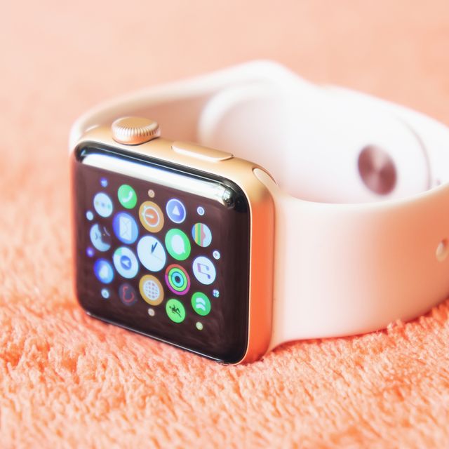chisinau, moldova   august 2019 apple watch series 3 38mm gold aluminum case with pink sand sport band on a soft fluffy peach colored background