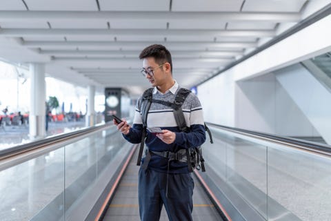 asian man waiting for the plane at the airport