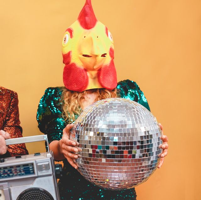 crazy stylish people listening music with vintage boombox stereo   fashion couple wearing t rex and chicken mask at party fest event    absurd, holidays and funny trend concept   focus on man face