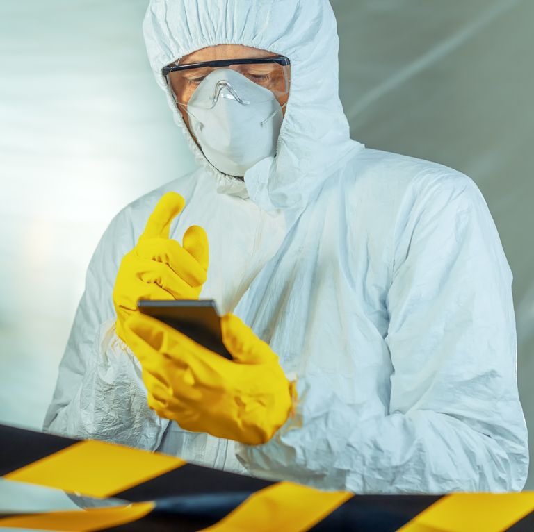Epidemiologist using smartphone in hospital virus infection quarantine