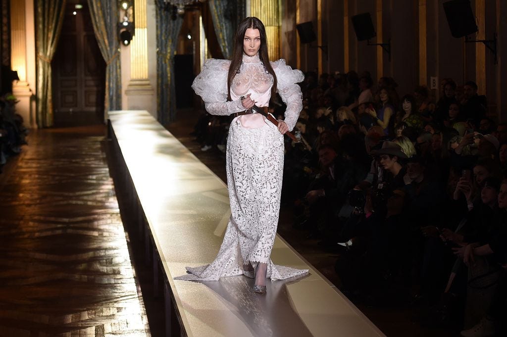 Bella Hadid Frees The Nipple In A Wedding Gown During PFW