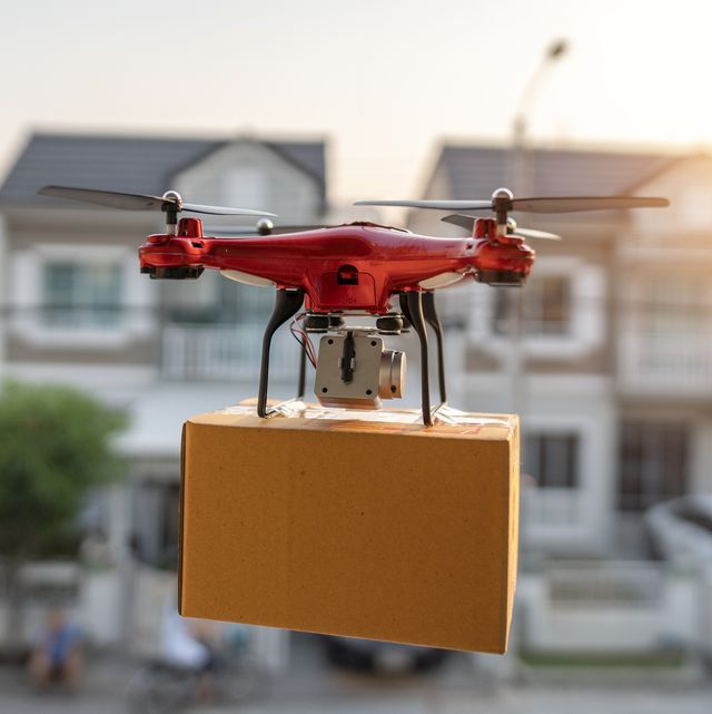 on 23 february 2020, bangkok, thailand delivery drone carrying urgent shipment box in a city