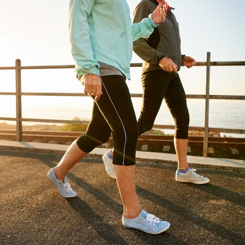 cropped shot of two senior women walking together in morning