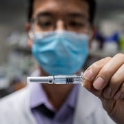 CHINA-HEALTH-VIRUS in this picture taken on april 29, 2020, an engineer shows an experimental vaccine for the covid 19 coronavirus that was tested at the quality control laboratory at the sinovac biotech facilities in beijing sinovac biotech, which is conducting one of the four clinical trials that have been authorised in china, has claimed great progress in its research and promising results among monkeys photo by nicolas asfouri afp to go with health virus china vaccine,focus by patrick baert photo by nicolas asfouriafp via getty images