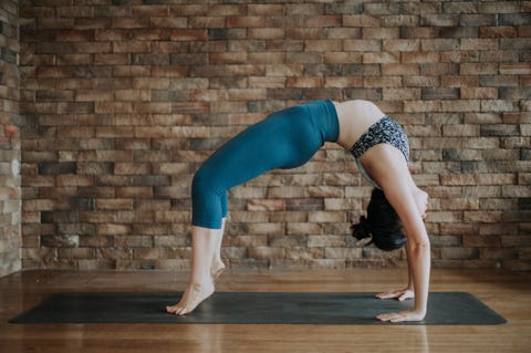an asian chinese female yoga instructor with bridge pose 橋式