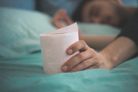 sleeping man holding toilet paper