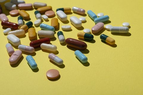 view of assorted pills on yellow backgroundstudio shot