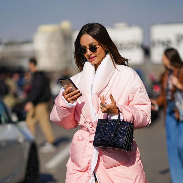 milan, italy   february 22 patricia contreras wears quay sunglasses, rings, a light pink puffer coat with a white inner lining, a shiny black crocodile pattern handbag, fuchsia tie and dye socks, outside msgm, during milan fashion week fallwinter 2020 2021 on february 22, 2020 in milan, italy photo by edward berthelotgetty images