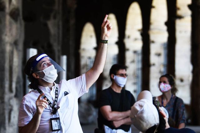 a guide l gives a conducted tour to visitors at the colosseum monument which reopens on june 1, 2020 in rome, while the country eases its lockdown aimed at curbing the spread of the covid 19 infection, caused by the novel coronavirus   the colosseum monument reopens on june 1, 2020 after having been closed since march 8, 2020, with adequate sanitary protection for staff and visitors, secure routes, compulsory reservations and modified schedules to avoid crowds at peak times photo by filippo monteforte  afp photo by filippo monteforteafp via getty images