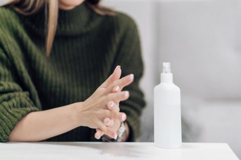 young woman sanitizes her hands to keep them clean and herself healthy