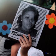 US-POLITICS-RACE-UNREST a demonstrator holds a sign with the image of breonna taylor, a black woman who was fatally shot by louisville metro police department officers, during a protest against the death george floyd in minneapolis, in denver, colorado on june 3, 2020 us protesters welcomed new charges brought wednesday against minneapolis officers in the killing of african american man george floyd but thousands still marched in cities across the country for a ninth straight night, chanting against racism and police brutality photo by jason connolly afp photo by jason connollyafp via getty images