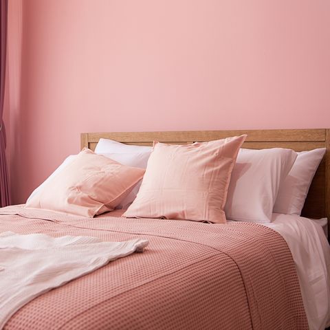 quarto interior do quarto com cama confortável perto da parede rosa