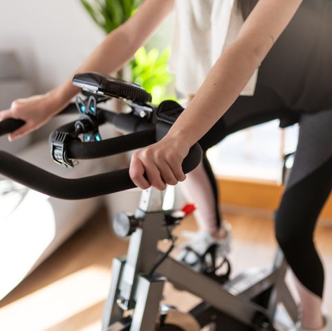 low section shot of a woman in sportswear exercising on an exercise bike at home