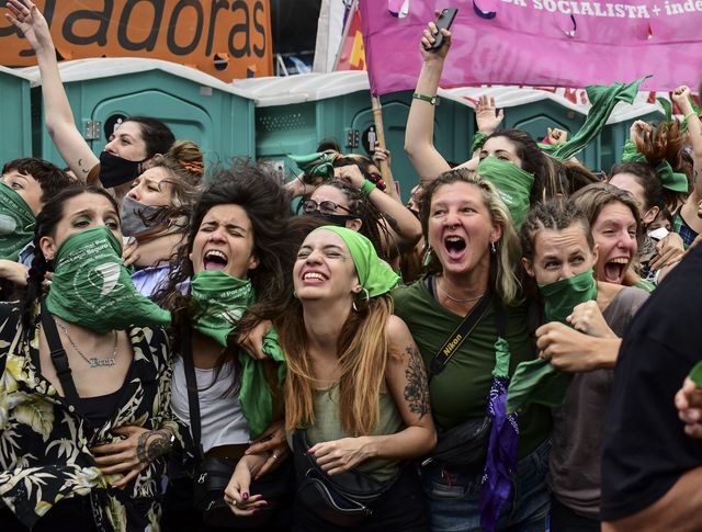 topshot   demonstrators celebrate with green headscarves   the symbol of abortion rights activists   outside the argentine congress in buenos aires on december 11, 2020, after legislators passed a bill to legalize abortion photo by ronaldo schemidt  afp photo by ronaldo schemidtafp via getty images