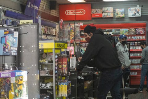 shoppers wear protective masks inside a gamestop corp store in san diego, california, us, on monday, jan 25, 2021 california, a recent epicenter of the coronavirus pandemic, has lifted its regional stay at home orders as the outbreak slows across the state and hospitalizations ease photographer bing guanbloomberg via getty images