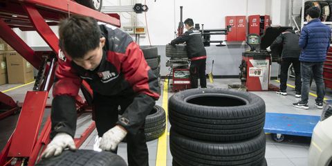 employees inspect tires at a tuhu repair and service center in shanghai, china, on wednesday, feb 3, 2021 the company is valued at 4 billion and is a major distributor of auto parts and chinas biggest internet based car maintenance service provider, according to founder chen min photographer qilai shenbloomberg via getty images