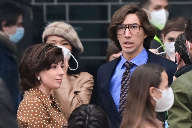 us singer, songwriter and actress lady gaga l and us actor adam driver r are pictured on march 11, 2021 on piazza duomo in central milan on the set of the new ridley scott movie about the gucci black widow patrizia reggiani, who was tried and convicted of orchestrating the assassination of her ex husband and former head of the gucci fashion house maurizio gucci   house of gucci, which stars lady gaga, adam driver, al pacino, jared leto, jack huston, reeve carney and jeremy irons, is an upcoming american biographical crime film directed by ridley scott, scheduled to be released in the united states on november 24, 2021 by metro goldwyn mayer photo by miguel medina  afp photo by miguel medinaafp via getty images