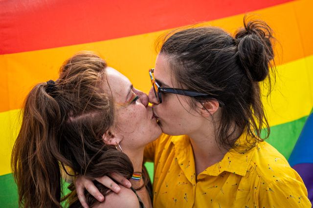 piazza castello, turin, italy   20210605 two girls kiss during a lgbt demonstration for the approval of the zan law, against homophobia the new zan law, referring to alessandro zan, a left wing democratic member of parliament, aims at more protection for gays, lesbians, trans and bisexuals photo by nicolò campolightrocket via getty images
