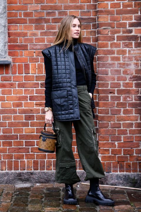 copenhagen, denmark   february 01 tine andrea lauvli wearing a black vest, a black pullover, dark green pants, black boots and a brown bag by louis vuitton, seen at the gestuz fashion show during copenhagen fashion week autumnwinter 2022 on february 1, 2022 in copenhagen, denmark photo by streetstyleshootersgetty images