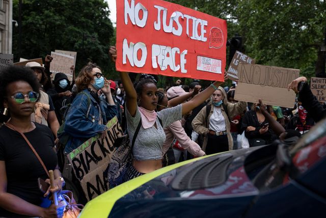 london, england   june 03 a police van is pushed back by demonstrators during a black lives matter protest on june 3, 2020 in london, united kingdom the death of an african american man, george floyd, while in the custody of minneapolis police has sparked protests across the united states, as well as demonstrations of solidarity in many countries around the world photo by dan kitwoodgetty images