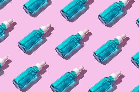 transparent blue bottle liquid dropper 
on pink pastel background hyaluronic acid and collagen anti aging facial skin care and bodies for summer sun seamless pattern