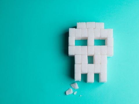 skull made of sugar cubes with a broken tooth concept of tooth decay