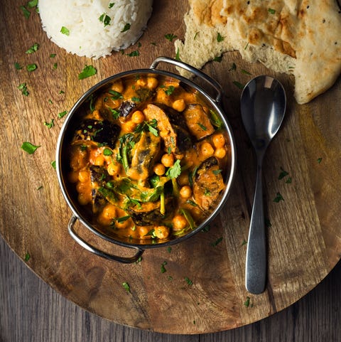 homemade freshness aubergine, chickpea, spinach vegan tika masala service with boiled basmati rice and naan bread, sprinkled fine chopped coriander for garnish