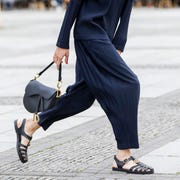 Street Style - Berlin - July 22, 2020 berlin, germany july 22 trend scout julian daynov, wearing dark blue plisse pants and a dark blue plisse top by issey miyake, a white mini bag by jil sander, white sneakers by common projects, a dark blue cap by prada and sunglasses by celine during a street style shooting on july 22, 2020 in berlin, germany photo by streetstyleographgetty images