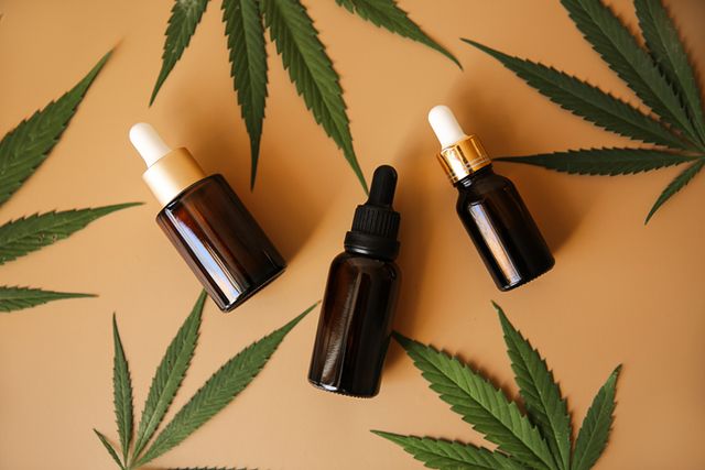 glass bottles with cbd oil and hemp leaves