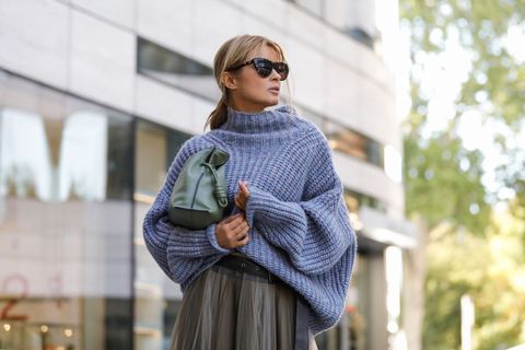 dusseldorf, germany   september 08 influencer gitta banko wearing an oversized blue grey knitted pullover by isabel marant, a grey maxi tulle skirt with a black leather belt by brunello cucinelli, black boots by copenhagen, a green flamenco clutch bag by loewe and sunglasses by bottega veneta during a street style shooting on september 8, 2020 at breuninger in dusseldorf, germany photo by streetstyleshootersgetty images