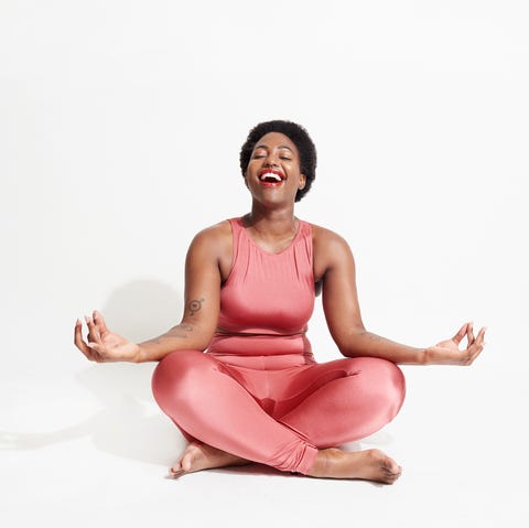 Laughing woman in lotus position